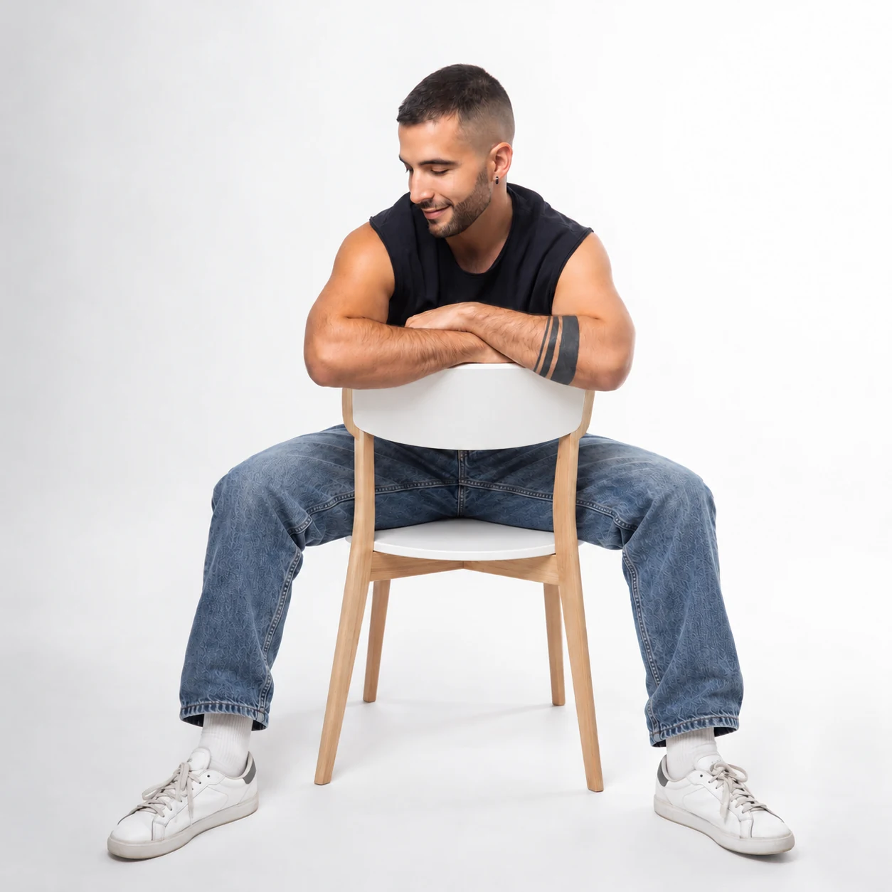 Chris Turina seated on a white-and-wood chair